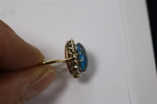 A yellow metal, opal and diamond oval cluster ring, size O.